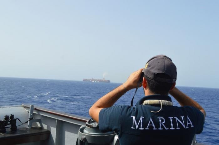 EUNAVFOR Flagship ITS DE LA PENNE escorting the merchant vessel.